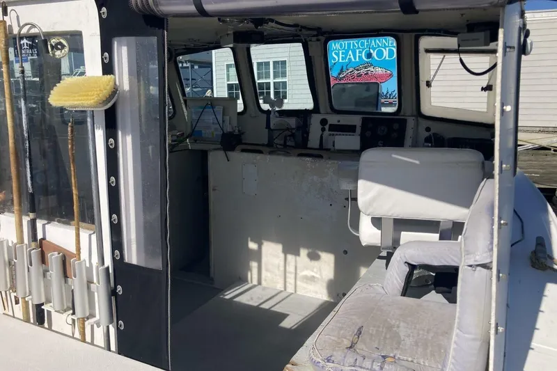 Slide: The Image of Interior of a 1986 BGM Custom boat with seating and cleaning tools. - 25