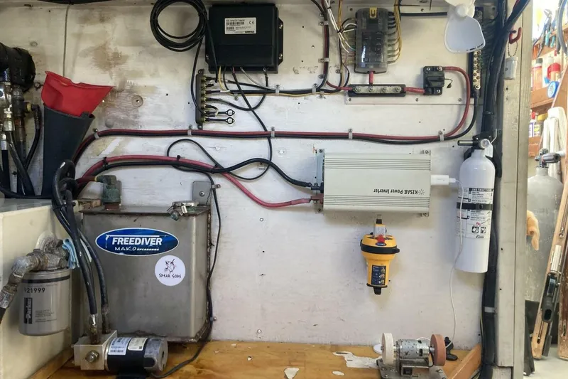 Slide: The Image of Electrical setup in a BGM Custom 1986 vehicle, featuring wiring, inverter, and fire extinguisher. - 21