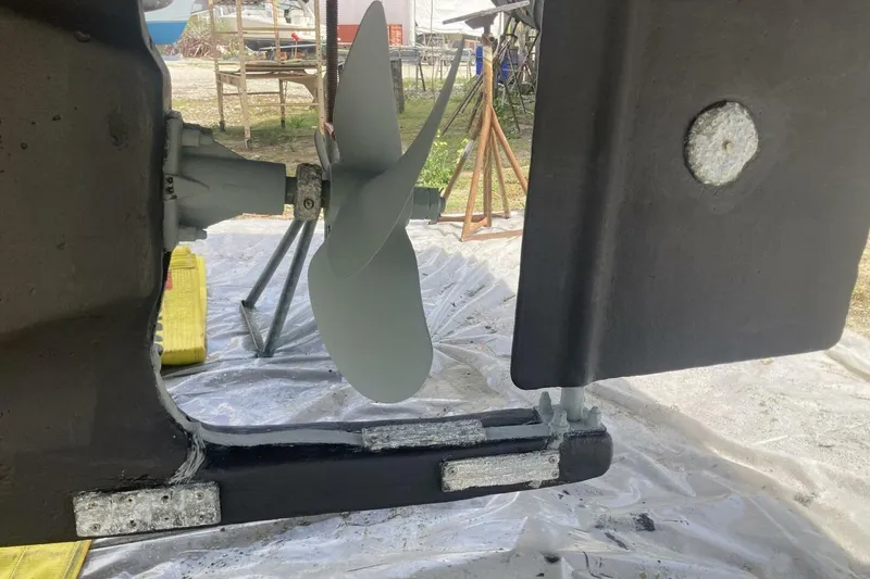 Slide: The Image of 1986 BGM Custom boat propeller and rudder in a maintenance setting. - 41