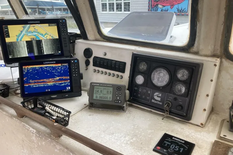 Slide: The Image of Boat dashboard with Lowrance displays and marine gauges, BGM Custom 1986 model. - 36