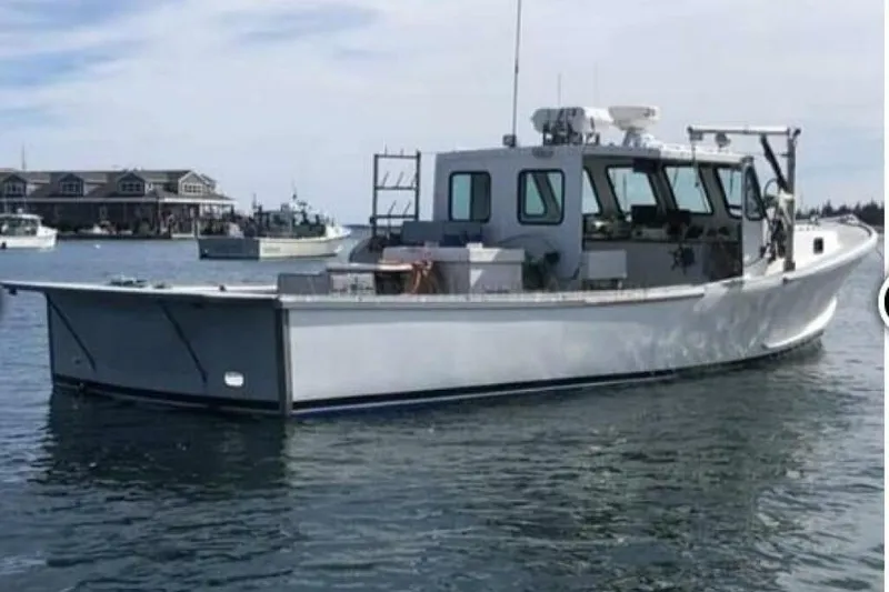 The Image of 1986 BGM Custom boat on calm water near docks and buildings. - 1