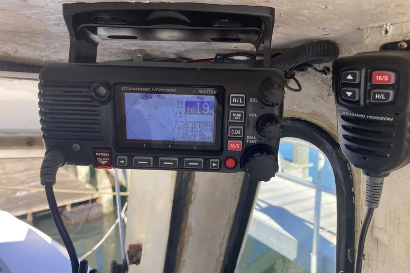 Slide: The Image of Marine radio equipment inside a 1986 BGM Custom boat, featuring Standard Horizon Matrix display. - 8