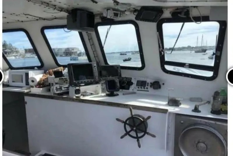 Slide: The Image of Interior of a 1986 BGM Custom boat with navigation equipment and scenic harbor view. - 7