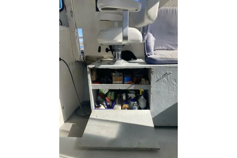 Slide: The Image of 1986 BGM Custom boat interior with storage cabinet and swivel chair. - 27