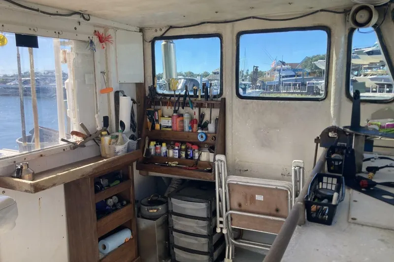 Slide: The Image of Interior of a 1986 BGM Custom boat with tools and supplies by a window. - 24