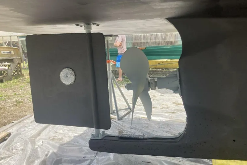 Slide: The Image of 1986 BGM Custom boat propeller and rudder in maintenance setting. - 39