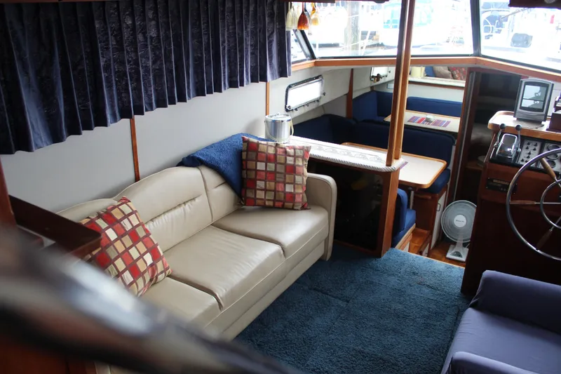 Slide: The Image of Interior of 1987 Carver 36 Aft Cabin Motor Yacht with cozy seating and nautical decor. - 14