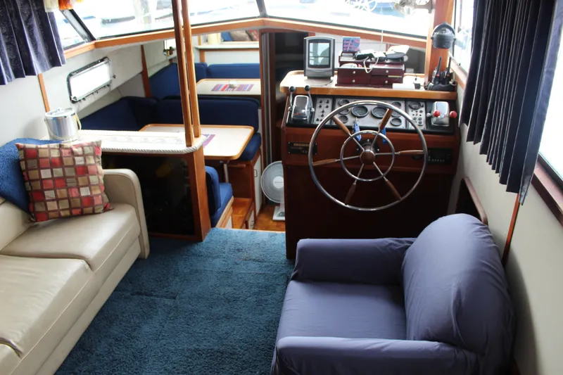 Slide: The Image of Interior of 1987 Carver 36 Aft Cabin Motor Yacht with helm, seating, and dining area. - 15