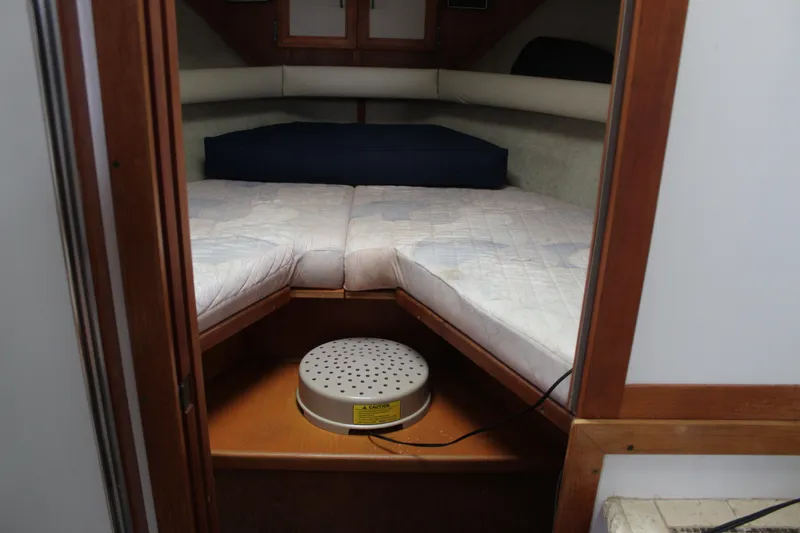 Slide: The Image of 1987 Carver 36 Aft Cabin Motor Yacht interior cabin with twin beds and wooden finish. - 22