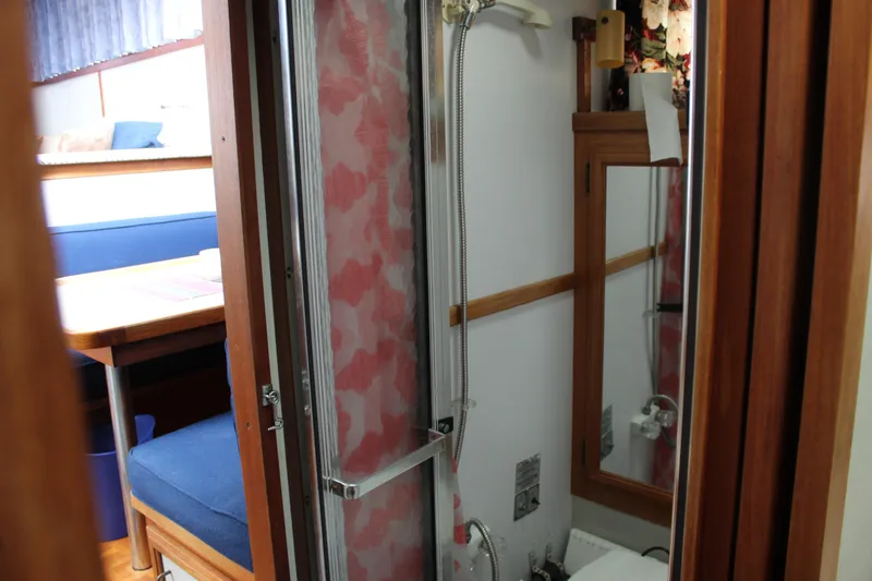Slide: The Image of 1987 Carver 36 Aft Cabin Motor Yacht interior with shower and seating area. - 23