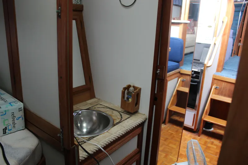 Slide: The Image of Interior of 1987 Carver 36 Aft Cabin Motor Yacht with sink and wooden cabinetry. - 24