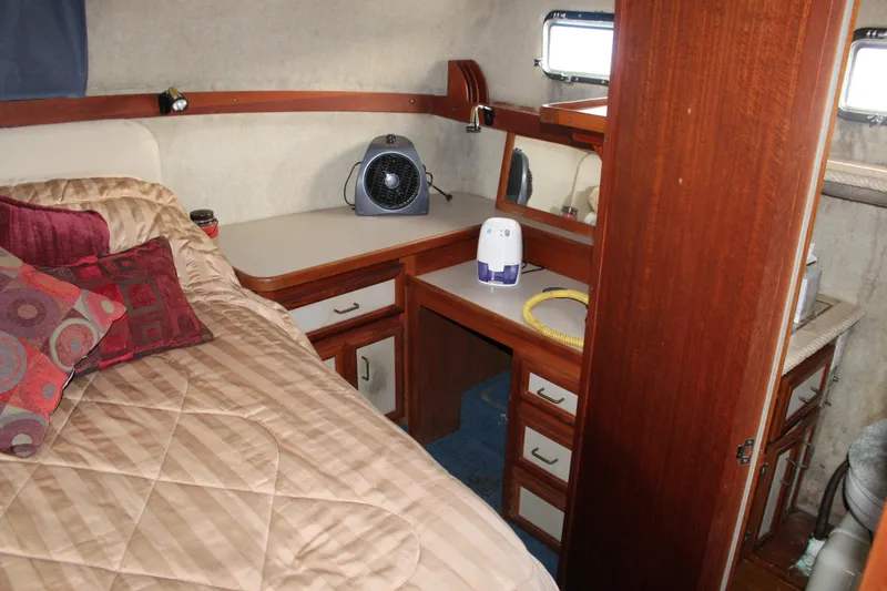 Slide: The Image of Cozy cabin interior of 1987 Carver 36 Aft Cabin Motor Yacht with bed and storage. - 26