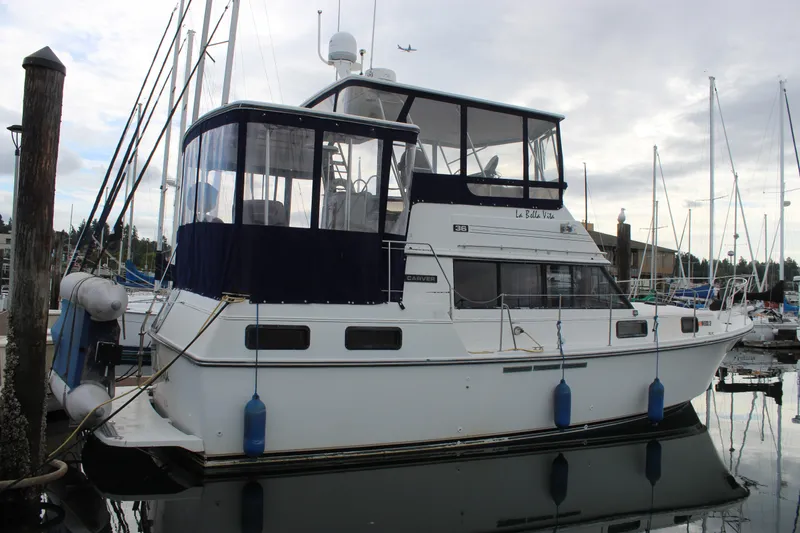 Slide: The Image of 1987 Carver 36 Aft Cabin Motor Yacht docked at marina, overcast sky. - 4