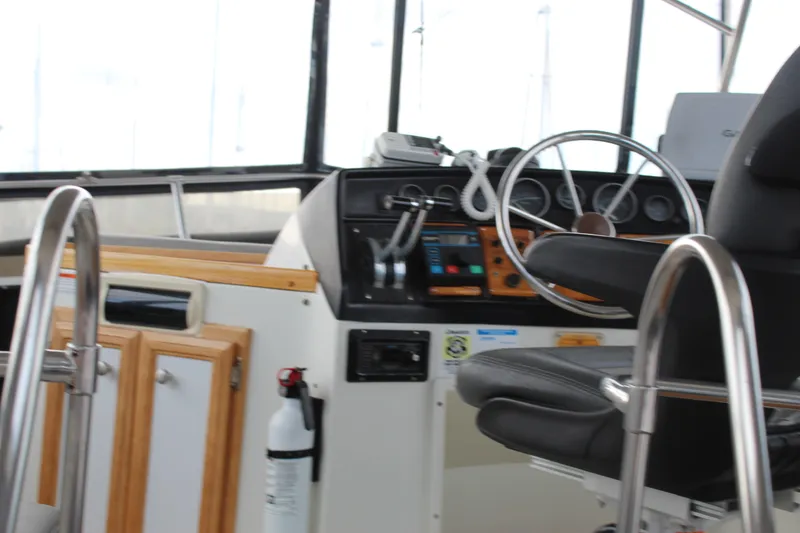Slide: The Image of Interior helm of 1987 Carver 36 Aft Cabin Motor Yacht with steering wheel and controls. - 5