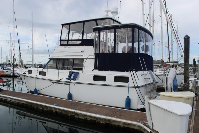 The Image of 1987 Carver 36 Aft Cabin Motor Yacht docked at marina, side view. - 1
