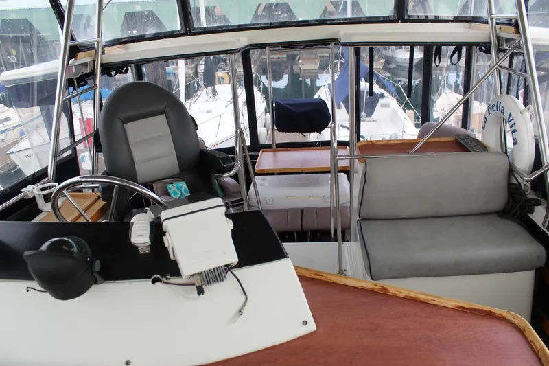 Slide: The Image of 1987 Carver 36 Aft Cabin Motor Yacht interior with helm and seating area. - 10