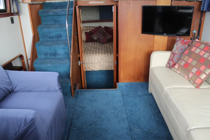 Slide: The Image of Interior of 1987 Carver 36 Aft Cabin Motor Yacht with blue carpet and cozy seating. - 18