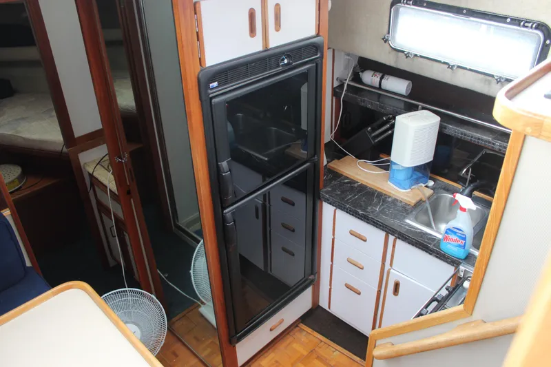 Slide: The Image of Interior of 1987 Carver 36 Aft Cabin Motor Yacht kitchen with appliances and sink. - 19