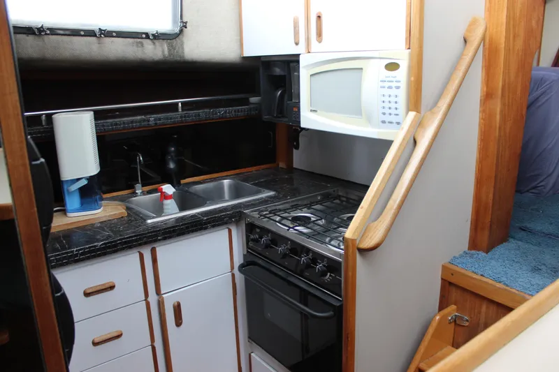 Slide: The Image of Compact kitchen in 1987 Carver 36 Aft Cabin Motor Yacht with stove, microwave, and sink. - 20
