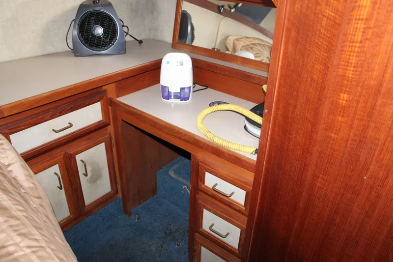 Slide: The Image of 1987 Carver 36 Aft Cabin Motor Yacht interior with wooden cabinetry and appliances. - 28