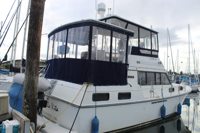 Slide: The Image of 1987 Carver 36 Aft Cabin Motor Yacht docked at marina, featuring blue canopy. - 3