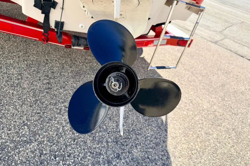 Slide: The Image of Propeller of a 2003 Glastron/Carlson GX180 boat on a trailer. - 15