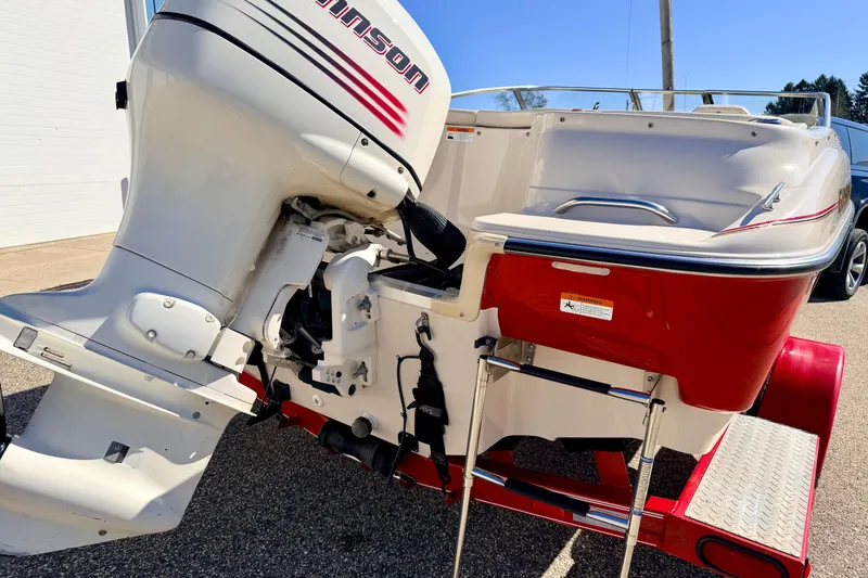 Slide: The Image of 2003 Glastron/Carlson GX180 boat with Johnson outboard motor, red and white design. - 16