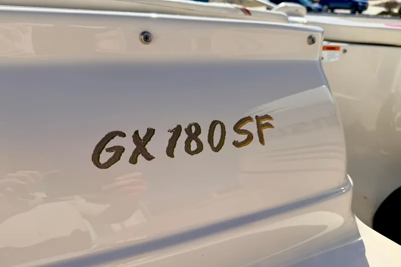 Slide: The Image of 2003 Glastron/Carlson GX180 boat model lettering on white surface. - 18