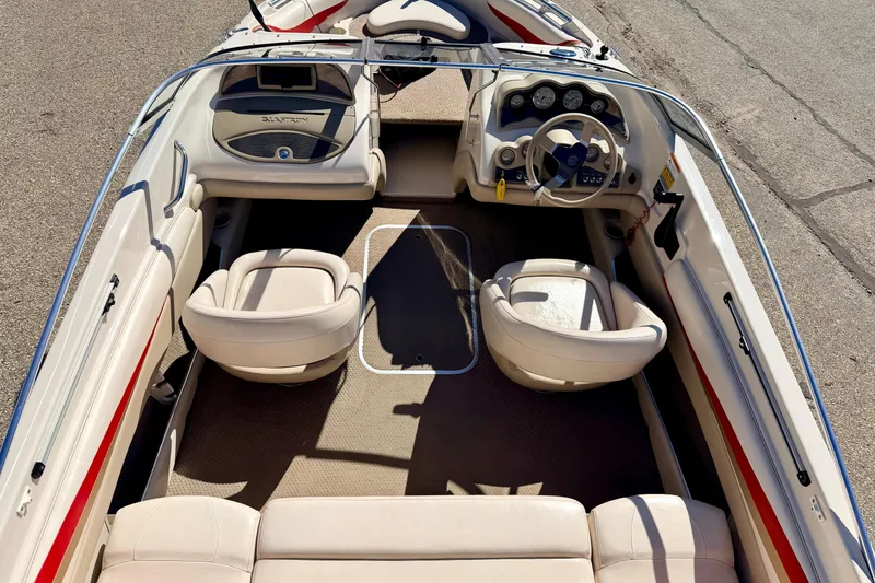 Slide: The Image of 2003 Glastron/Carlson GX180 boat interior with beige seating and dashboard controls. - 19