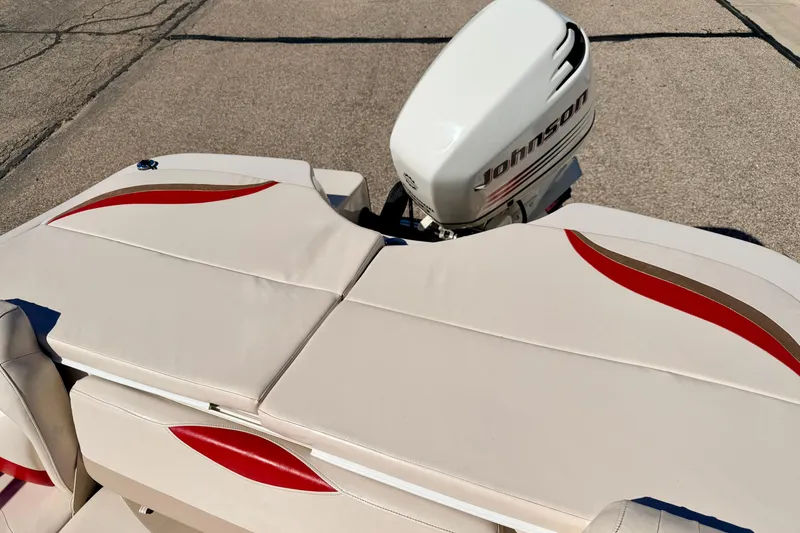 Slide: The Image of 2003 Glastron/Carlson GX180 boat with Johnson outboard motor, featuring beige and red upholstery. - 21