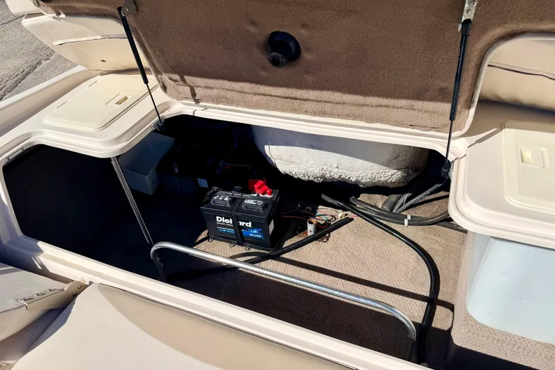 Slide: The Image of Open storage compartment of 2003 Glastron/Carlson GX180 boat with battery and wiring. - 22