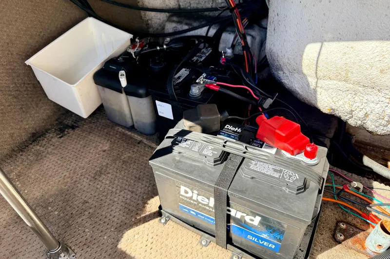 Slide: The Image of 2003 Glastron/Carlson GX180 boat battery compartment with DieHard Silver battery and wiring. - 23