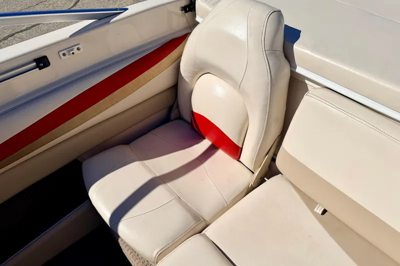 Slide: The Image of 2003 Glastron/Carlson GX180 boat interior with beige and red seating. - 24