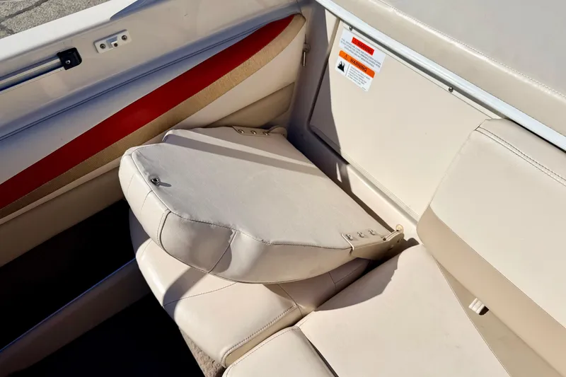 Slide: The Image of 2003 Glastron/Carlson GX180 boat interior with beige seating and red accent. - 25