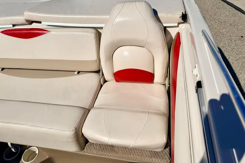 Slide: The Image of 2003 Glastron/Carlson GX180 boat interior with beige and red seating. - 26