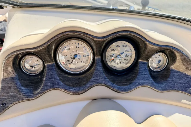 Slide: The Image of Dashboard of a 2003 Glastron/Carlson GX180 boat with gauges and controls. - 31