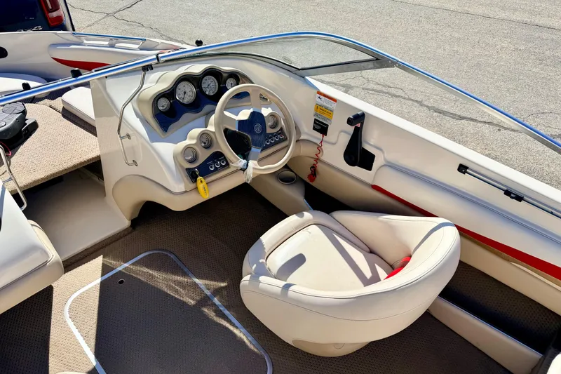 Slide: The Image of 2003 Glastron/Carlson GX180 boat interior with steering wheel and dashboard controls. - 36