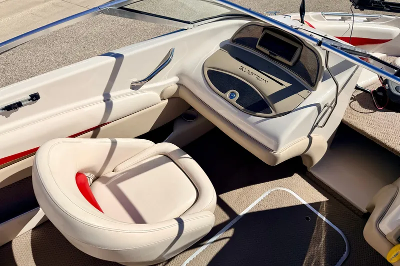 Slide: The Image of 2003 Glastron/Carlson GX180 boat interior with beige seating and dashboard. - 37