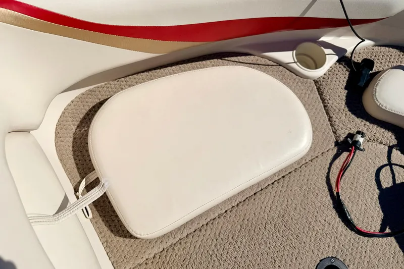 Slide: The Image of 2003 Glastron/Carlson GX180 boat interior with beige upholstery and red accent. - 46