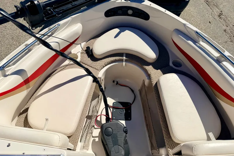 Slide: The Image of 2003 Glastron/Carlson GX180 boat interior with white seating and red accents. - 47