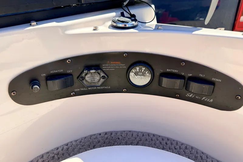 Slide: The Image of Control panel of a 2003 Glastron/Carlson GX180 boat with various switches and gauges. - 50