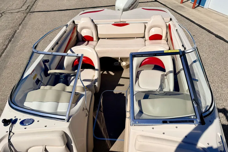Slide: The Image of 2003 Glastron/Carlson GX180 boat interior with beige and red seating, open windshield. - 51