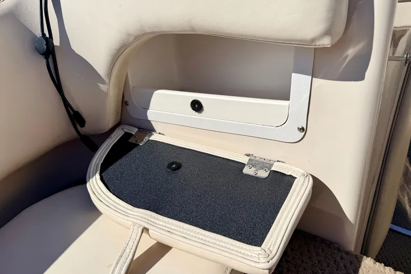 Slide: The Image of 2003 Glastron/Carlson GX180 boat interior storage compartment with cushioned seating. - 53