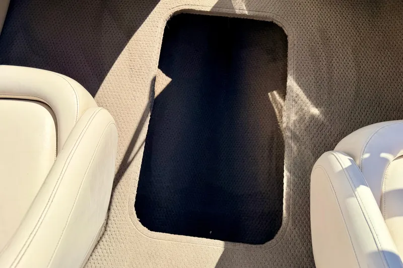 Slide: The Image of 2003 Glastron/Carlson GX180 boat interior with beige seats and carpeted flooring. - 55