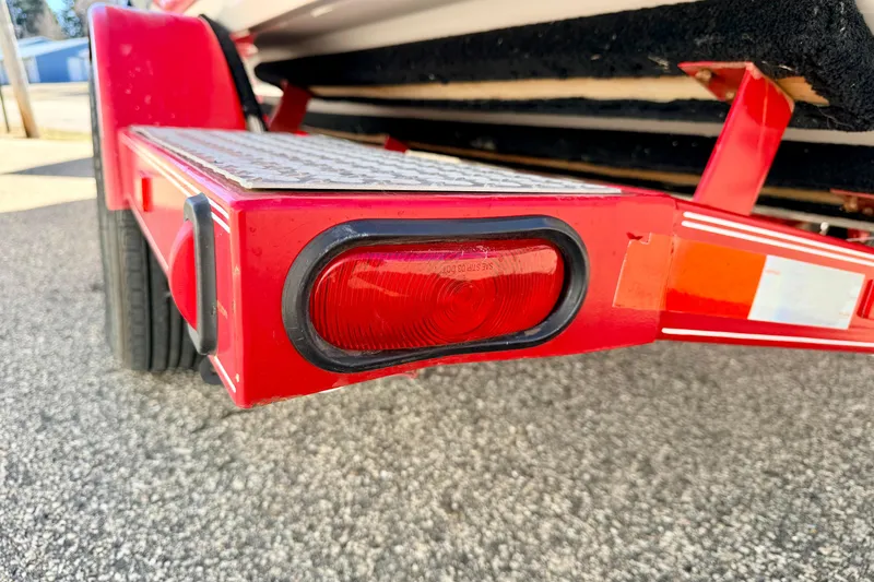 Slide: The Image of Red trailer light on a 2003 Glastron/Carlson GX180 boat trailer. - 56