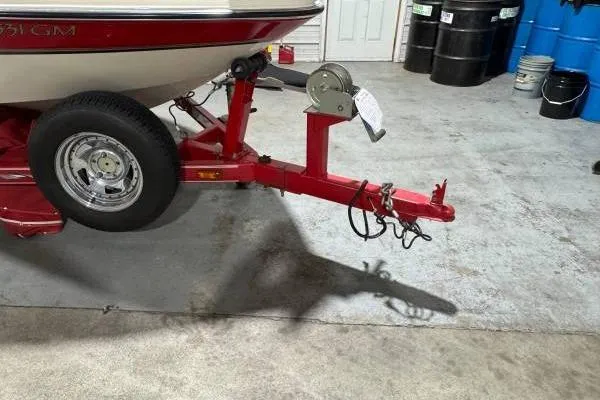 Slide: The Image of Red Glastron GX180 boat trailer detail, 2003 model, on pavement. - 6