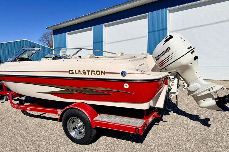 Slide: The Image of 2003 Glastron/Carlson GX180 boat with Johnson 150 outboard motor on red trailer. - 63