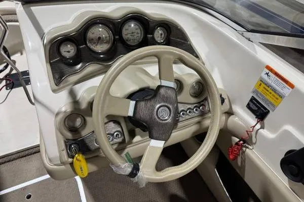 Slide: The Image of 2003 Glastron/Carlson GX180 boat with red and white detailing on a trailer. - 7