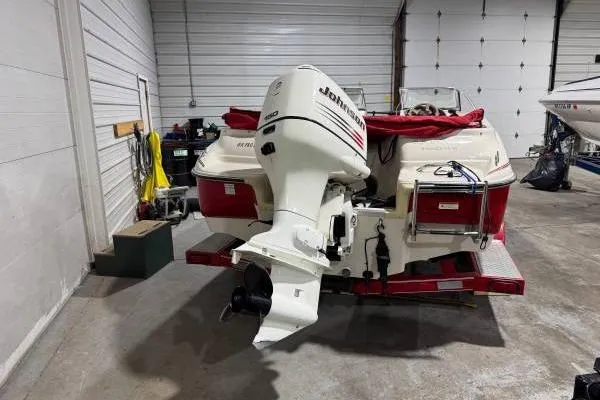 Slide: The Image of 2003 Glastron/Carlson GX180 boat with bold logo and sleek design. - 8