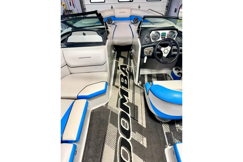 Slide: The Image of Open storage compartment in 2012 Moomba Mojo 2.5 boat, featuring blue and gray interior. - 12